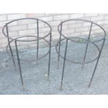 A pair of wrought iron circular garden table bases, lacking tops, 62cm high, 40cm diameter.