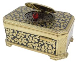 A 20thC gilt metal and black enamelled musical bird box, the hinged lid opening to reveal a red bird