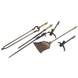 Three various fire irons, each with a differing brass handle, pair of shaped iron fire dogs, and a k