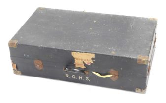 An ebonised canvas and timber military case for suits, initialed R.G.H.S, and with label for The Bri