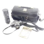 An Olympus OM1 camera, with long lens, etc.
