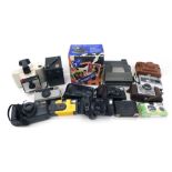 A group of camera equipment, comprising a Polaroid 600 Instant camera, a Polaroid Image System camer