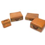A suite of four pieces of brown leather luggage, each stamped A Norris Product with Tartan lined int