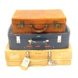 A cream pig skin suitcase, initialled HAS, 66cm wide, and a brown leather case, 50cm wide, and blue