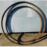 A 19thC iron cart wheel rim, 137.5cm diameter, and another, 117cm diameter. (2)
