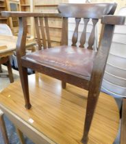 An oak smoker's bow chair, with leather drop in seat.