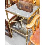 A pair of smoked glass and brass side tables.