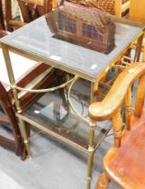 A pair of smoked glass and brass side tables.