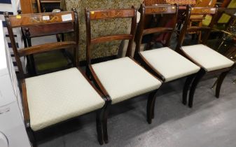 A set of four Regency style mahogany dining room chairs, with gilt inlay and drop in seats, in turqu