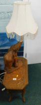 A carved hardwood elephant table and associated lamp. WARNING! This lot contains untested or