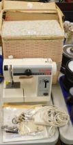 Withdrawn pre-sale. A Singer electric sewing machine and sewing basket.