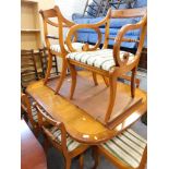 A yew wood extending dining table, and a set of six (4+2) chairs, in Regency striped material. The u