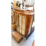 An oak cased Singer sewing machine, and a bow front display cabinet. (2)