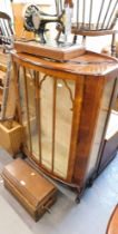 An oak cased Singer sewing machine, and a bow front display cabinet. (2)