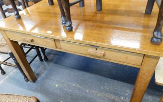 An oak rectangular desk, with two drawers, on tapered legs.