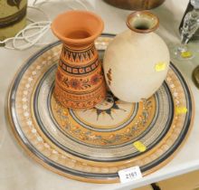 Eastern style terracotta chargers and two vases.