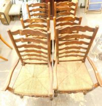 A set of six ladder back and rush seated late 19thC dining chairs.