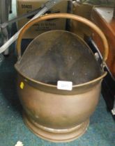 A copper coal scuttle.