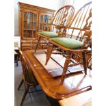 A substantial oak dining room suite, comprising an extending dining table with two additional leaves