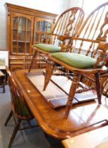 A substantial oak dining room suite, comprising an extending dining table with two additional leaves