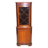 An Edwardian mahogany corner cupboard, with satinwood cross banding and shell patera inlay, the pedi