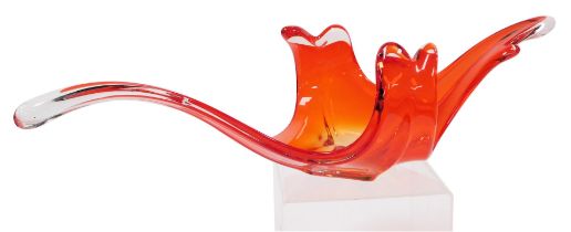 A late 20thC Murano orange glass bowl, of abstract form, raised on a square base, 79cm wide.