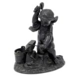 A spelter figure of a cherub with anvil.