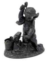 A spelter figure of a cherub with anvil.