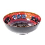 A Royal Doulton Sung flambe pottery bowl, decorated internally with a band of square lustre, printed
