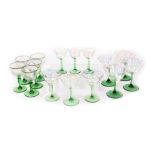 A group of mid century clear lustre glass and green stemmed wine glasses, champagne flutes and lique