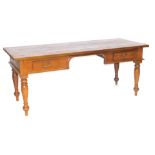 An Eastern hardwood kneehole desk, the rectangular top above two frieze drawers, raised on turned le