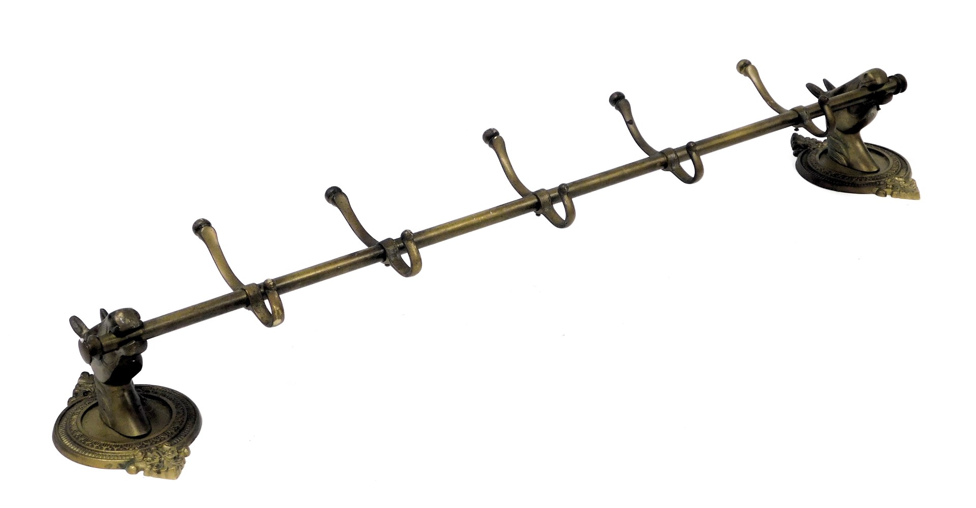 A brass wall hanging coat rack, the wall mounts formed as horse's head, on a circular and leaf cast