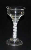 A Georgian late 18thC pan top wine glass, raised on a double opaque helix stem