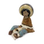 A Lladro matt porcelain figure of a Mexican Pancho boy, with a puppy at his feet, printed mark, 14cm