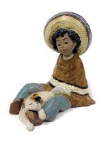 A Lladro matt porcelain figure of a Mexican Pancho boy, with a puppy at his feet, printed mark, 14cm