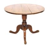 A George III oak occasional table, cut down, the circular top raised on a partially turned column ov