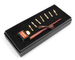 A calligraphy pen set, with seven different nibs, and a bottle of calligraphy Csee-Ink, boxed.