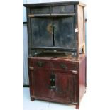 A Chinese hardwood side cupboard, with two frieze drawers above a pair of cupboard doors, raised on