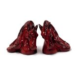 A pair of Flambe pottery bookends, modelled as horse's head, with swirling manes, 19cm high.