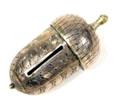 A small needlework item, made from white metal, in the form of an acorn.