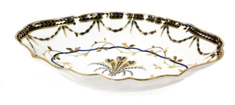 A first period Worcester porcelain dessert dish, of oval fluted form, decorated centrally in cobalt