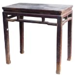 A Chinese red stained hardwood side table, with a carved frieze, raised on square legs, 86.5cm high,