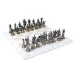 A chess set cast as Roman figures, brass and white metal, king 10.5cm high, together with a white an