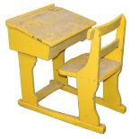 A Victorian yellow painted child's school desk, with integral seat, 75cm high, 78cm wide, 56cm deep.