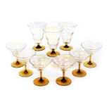 A set of mid century lustre clear glass and amber stemmed champagne flutes, together with three simi