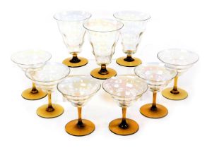 A set of mid century lustre clear glass and amber stemmed champagne flutes, together with three simi