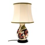 A Moorcroft Pirouette Breeze pottery table lamp, decorated against a cream ground, designed by Emma