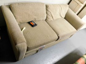 A two seater sofa with beige upholstery. Lots 1501 to 1590 are available to view and collect at our