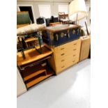 A framed bevelled mirror, standard lamp, a Dominion Luggage trunk, a chest of four long drawers,