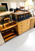 A framed bevelled mirror, standard lamp, a Dominion Luggage trunk, a chest of four long drawers,